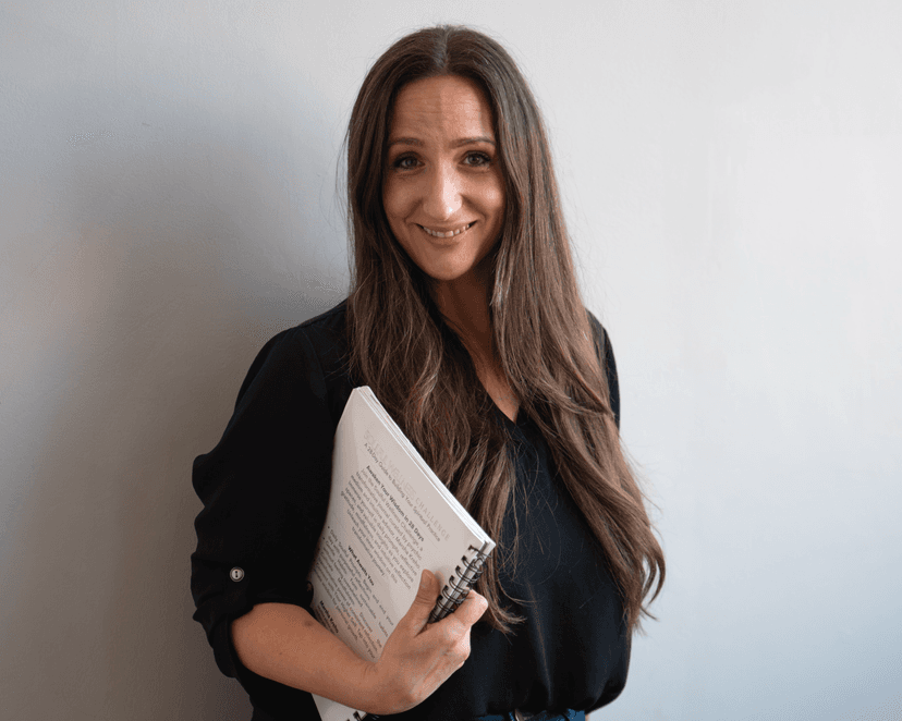 Marsha smiling, holding the Soulful Wellness Journal.